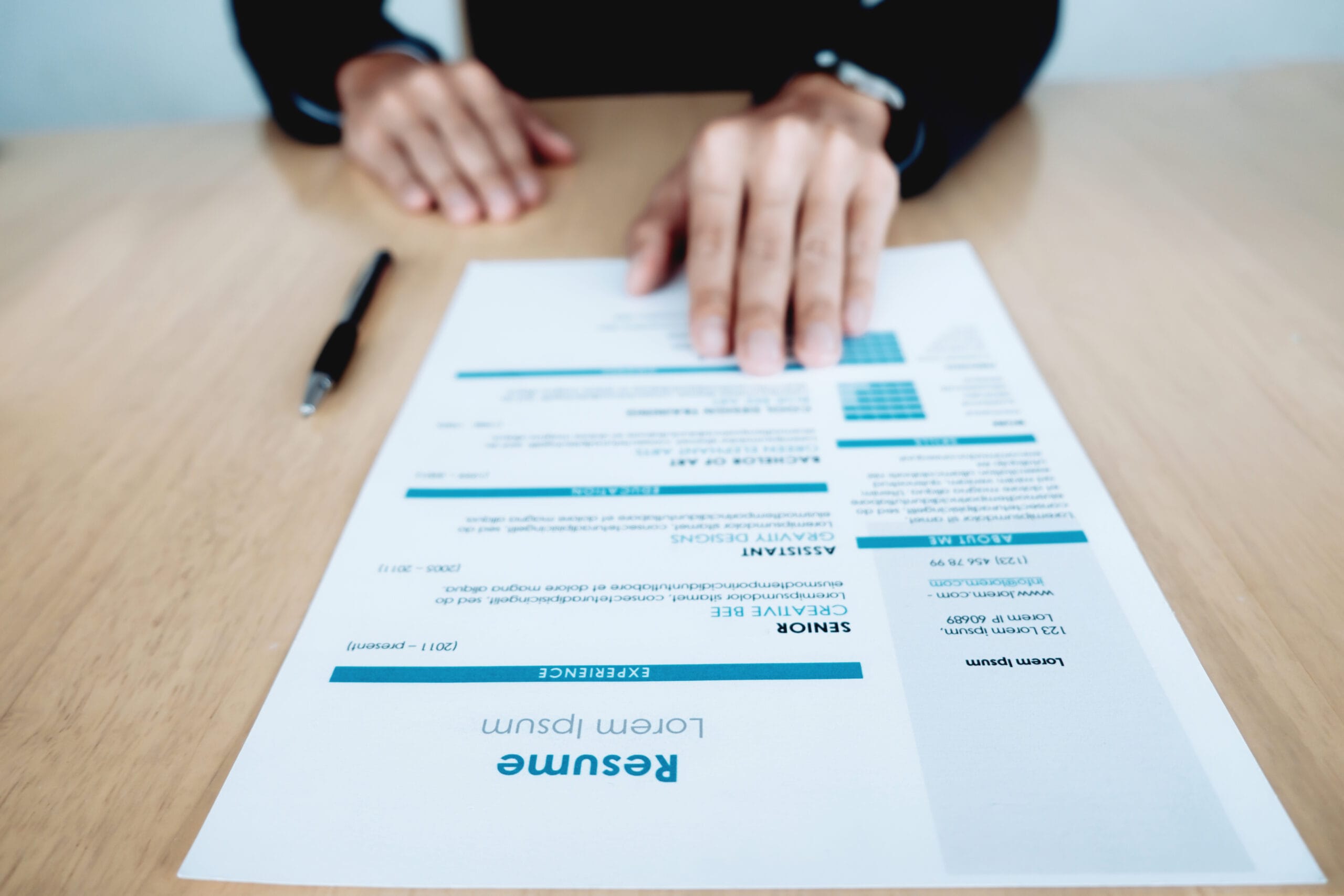 Close-up view of a resume on a desk featuring a personalized objective written by an AI resume objective generator